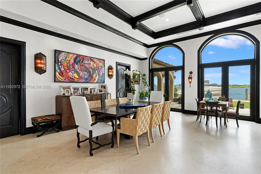 $34.5 Million Waterfront Estate Redefines Quiet Luxury in Bay Harbor Islands 11 Waterfront view of 10330 W Broadview Dr, a luxury home in Bay Harbor Islands for sale, featuring a Mediterranean-style design with open bay and Intracoastal views.