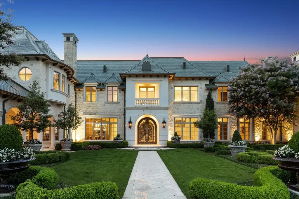 Château Lumièr in McKinney Lists for $14.65 Million as a French Chateau Estate Spanning Fifteen Wooded Acres 3 Front elevation of Château Lumièr at 1201 Gray Branch Rd in McKinney showcasing French Chateau architecture limestone façade symmetrical design and formal landscaped gardens at dusk.