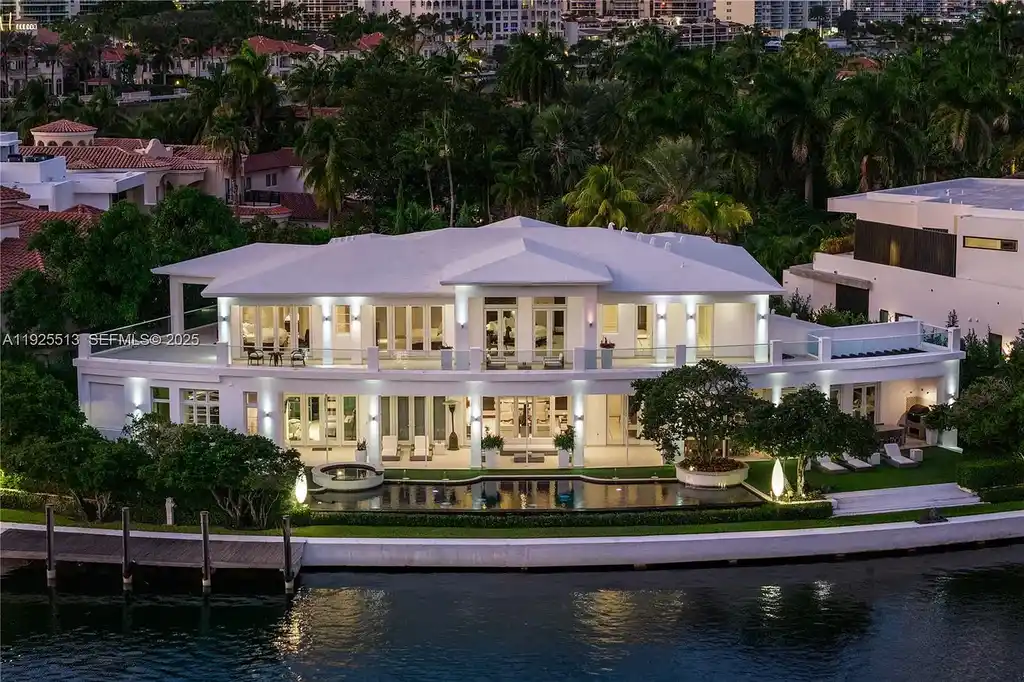 Aerial view of the luxurious $18,900,000 waterfront estate at 142 S Island in Golden Beach, showcasing private dock, expansive pool, and modern architectural design.