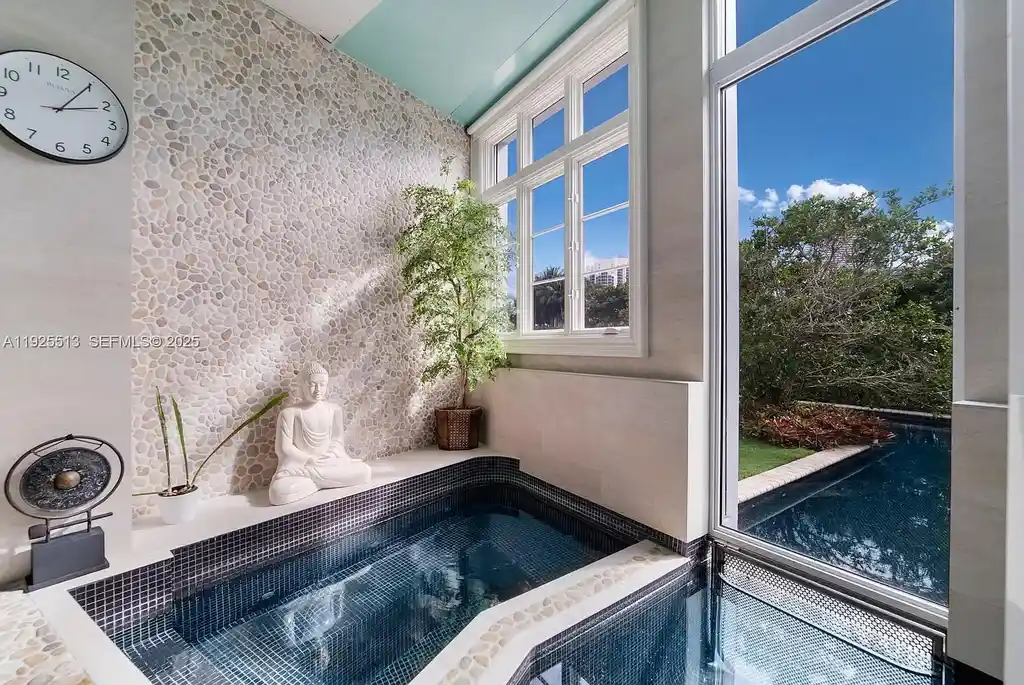 Aerial view of the luxurious $18,900,000 waterfront estate at 142 S Island in Golden Beach, showcasing private dock, expansive pool, and modern architectural design.