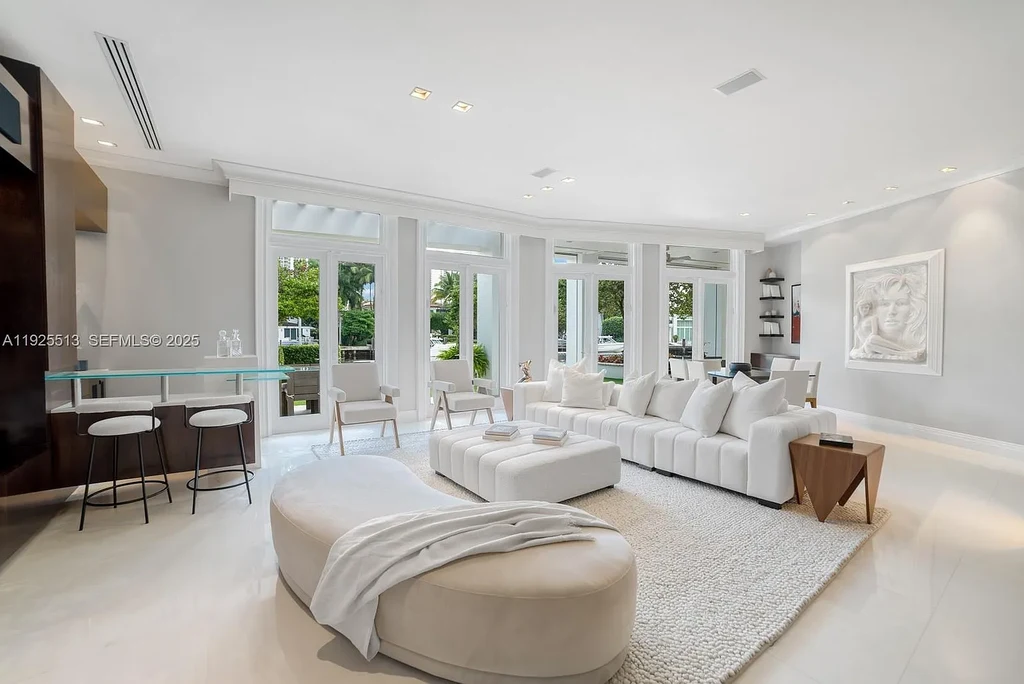 Aerial view of the luxurious $18,900,000 waterfront estate at 142 S Island in Golden Beach, showcasing private dock, expansive pool, and modern architectural design.