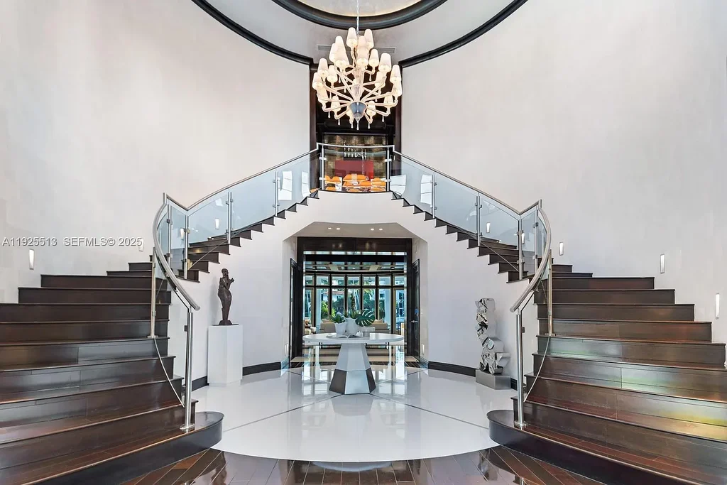 Aerial view of the luxurious $18,900,000 waterfront estate at 142 S Island in Golden Beach, showcasing private dock, expansive pool, and modern architectural design.