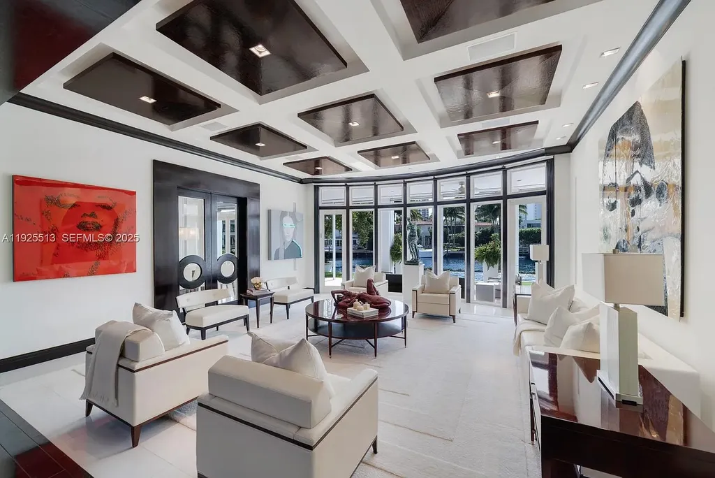 Aerial view of the luxurious $18,900,000 waterfront estate at 142 S Island in Golden Beach, showcasing private dock, expansive pool, and modern architectural design.