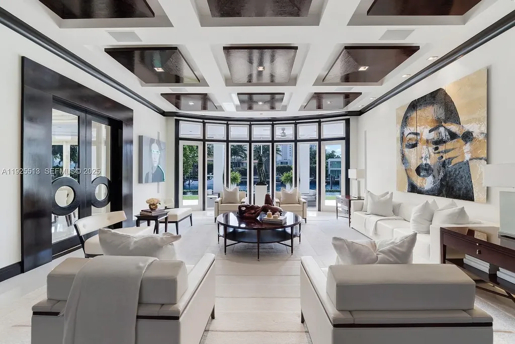 Aerial view of the luxurious $18,900,000 waterfront estate at 142 S Island in Golden Beach, showcasing private dock, expansive pool, and modern architectural design.