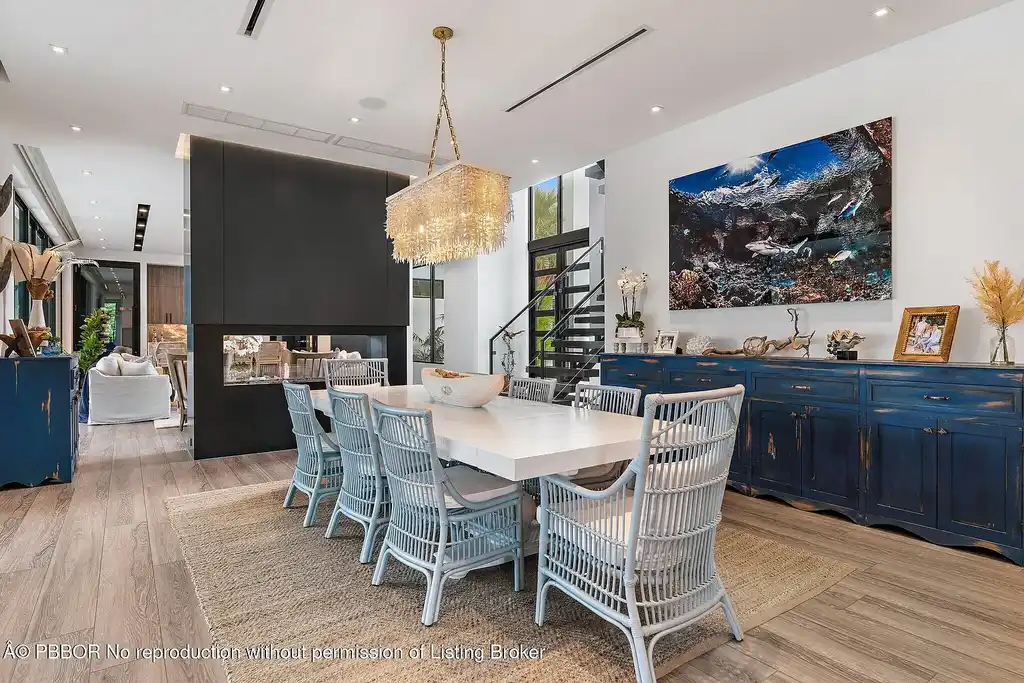 A $13 Million Peninsula Estate Redefines Waterfront Luxury Living in Jupiter, Florida 10 Waterfront backyard of a luxury home in Jupiter for sale, featuring a private dock and resort-style outdoor living