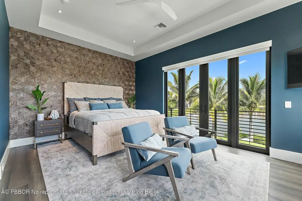 A $13 Million Peninsula Estate Redefines Waterfront Luxury Living in Jupiter, Florida 13 Waterfront backyard of a luxury home in Jupiter for sale, featuring a private dock and resort-style outdoor living