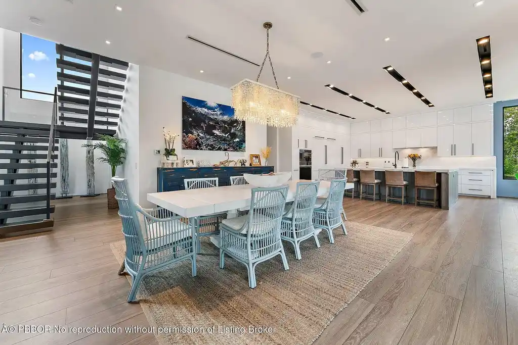 A $13 Million Peninsula Estate Redefines Waterfront Luxury Living in Jupiter, Florida 8 Waterfront backyard of a luxury home in Jupiter for sale, featuring a private dock and resort-style outdoor living