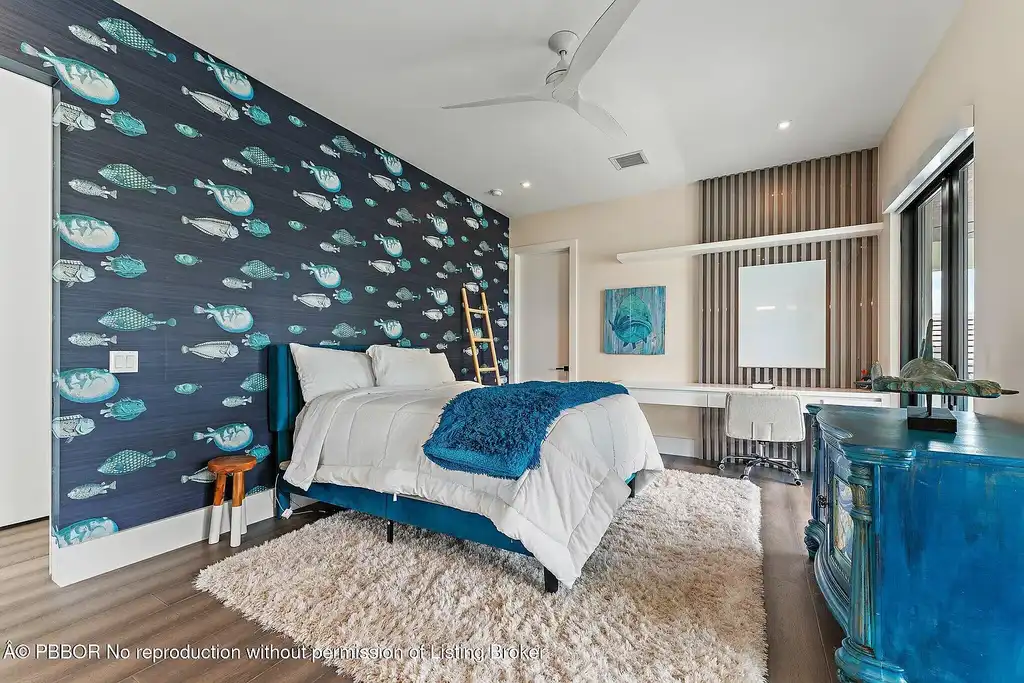 A $13 Million Peninsula Estate Redefines Waterfront Luxury Living in Jupiter, Florida 15 Waterfront backyard of a luxury home in Jupiter for sale, featuring a private dock and resort-style outdoor living