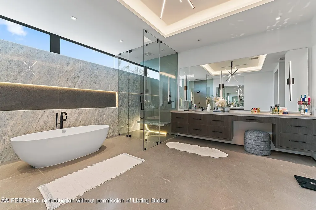 A $13 Million Peninsula Estate Redefines Waterfront Luxury Living in Jupiter, Florida 12 Waterfront backyard of a luxury home in Jupiter for sale, featuring a private dock and resort-style outdoor living