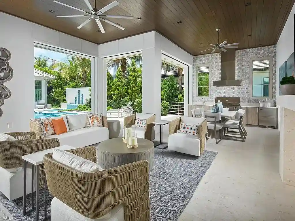 A $19.9 Million Stunning Tropical Contemporary Estate Steps From the Beach in Prestigious Naples 16 Tropical contemporary exterior of 2075 Gordon Dr E in Naples FL featuring a metal roof, stone accents, and lush landscaping near the beach