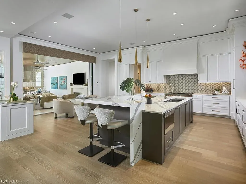 A $19.9 Million Stunning Tropical Contemporary Estate Steps From the Beach in Prestigious Naples 8 Tropical contemporary exterior of 2075 Gordon Dr E in Naples FL featuring a metal roof, stone accents, and lush landscaping near the beach