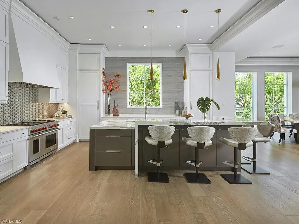 A $19.9 Million Stunning Tropical Contemporary Estate Steps From the Beach in Prestigious Naples 9 Tropical contemporary exterior of 2075 Gordon Dr E in Naples FL featuring a metal roof, stone accents, and lush landscaping near the beach