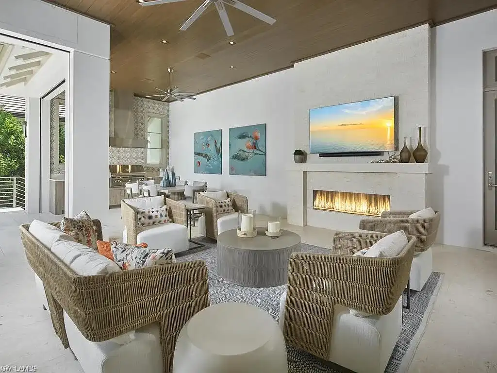 A $19.9 Million Stunning Tropical Contemporary Estate Steps From the Beach in Prestigious Naples 15 Tropical contemporary exterior of 2075 Gordon Dr E in Naples FL featuring a metal roof, stone accents, and lush landscaping near the beach