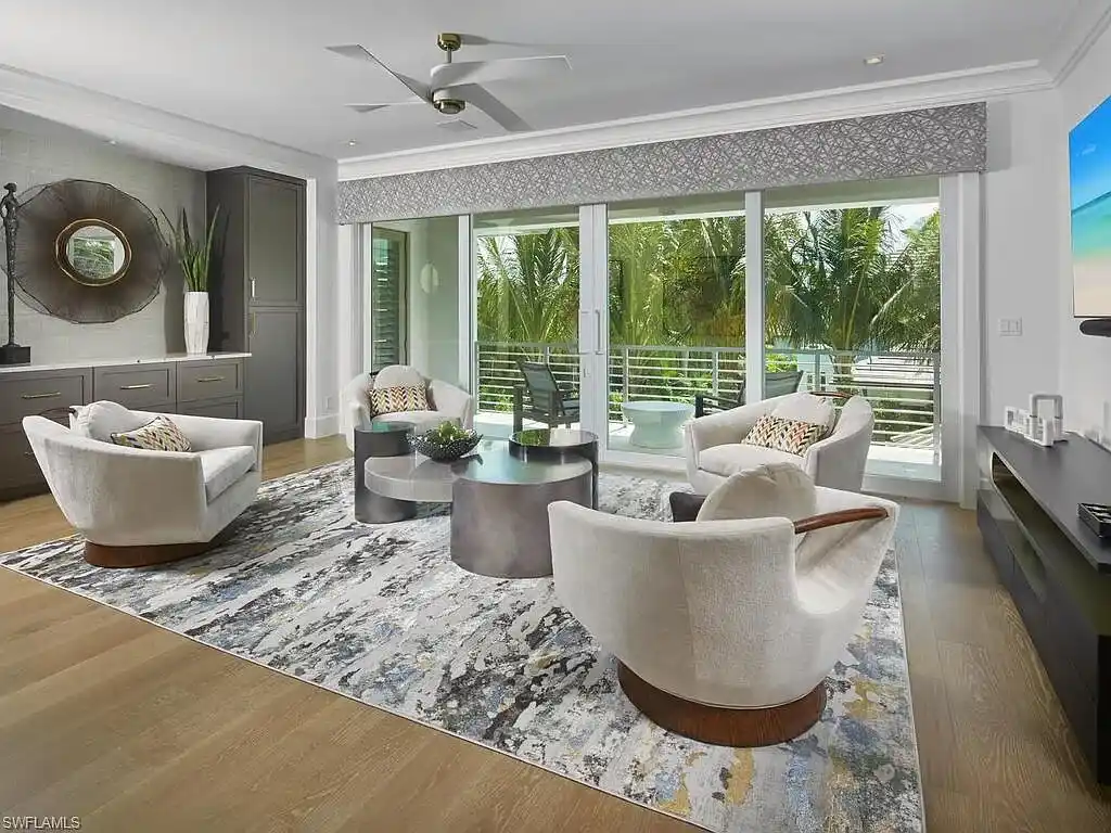 A $19.9 Million Stunning Tropical Contemporary Estate Steps From the Beach in Prestigious Naples 7 Tropical contemporary exterior of 2075 Gordon Dr E in Naples FL featuring a metal roof, stone accents, and lush landscaping near the beach