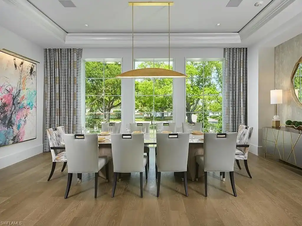 A $19.9 Million Stunning Tropical Contemporary Estate Steps From the Beach in Prestigious Naples 10 Tropical contemporary exterior of 2075 Gordon Dr E in Naples FL featuring a metal roof, stone accents, and lush landscaping near the beach