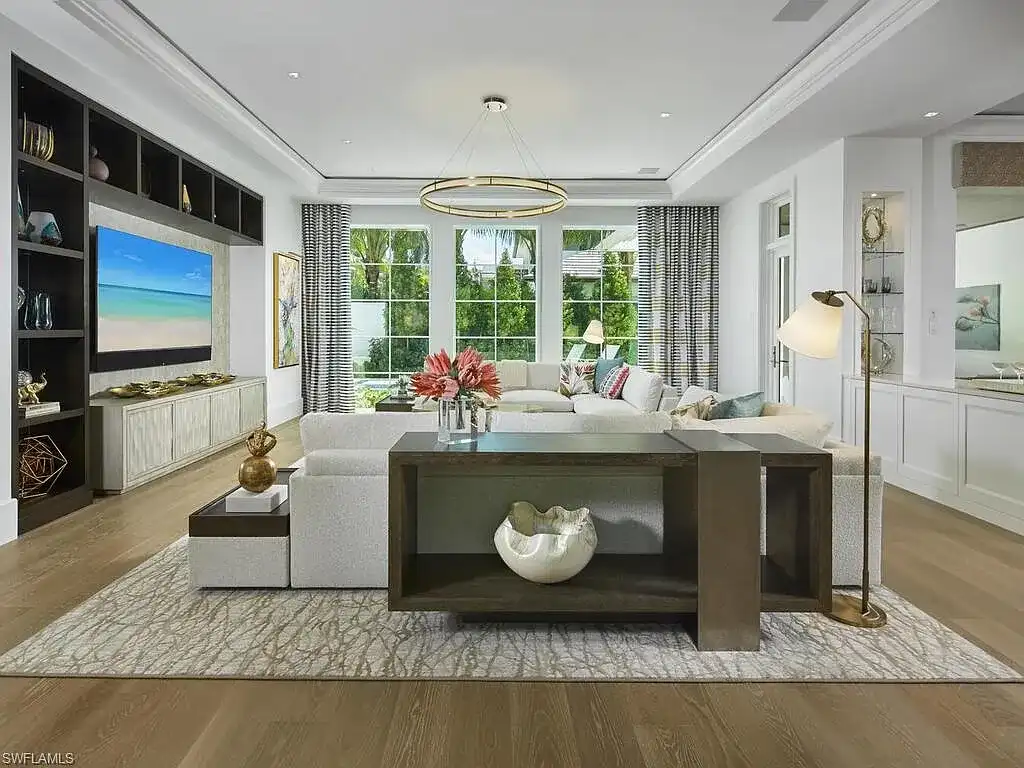 A $19.9 Million Stunning Tropical Contemporary Estate Steps From the Beach in Prestigious Naples 6 Tropical contemporary exterior of 2075 Gordon Dr E in Naples FL featuring a metal roof, stone accents, and lush landscaping near the beach