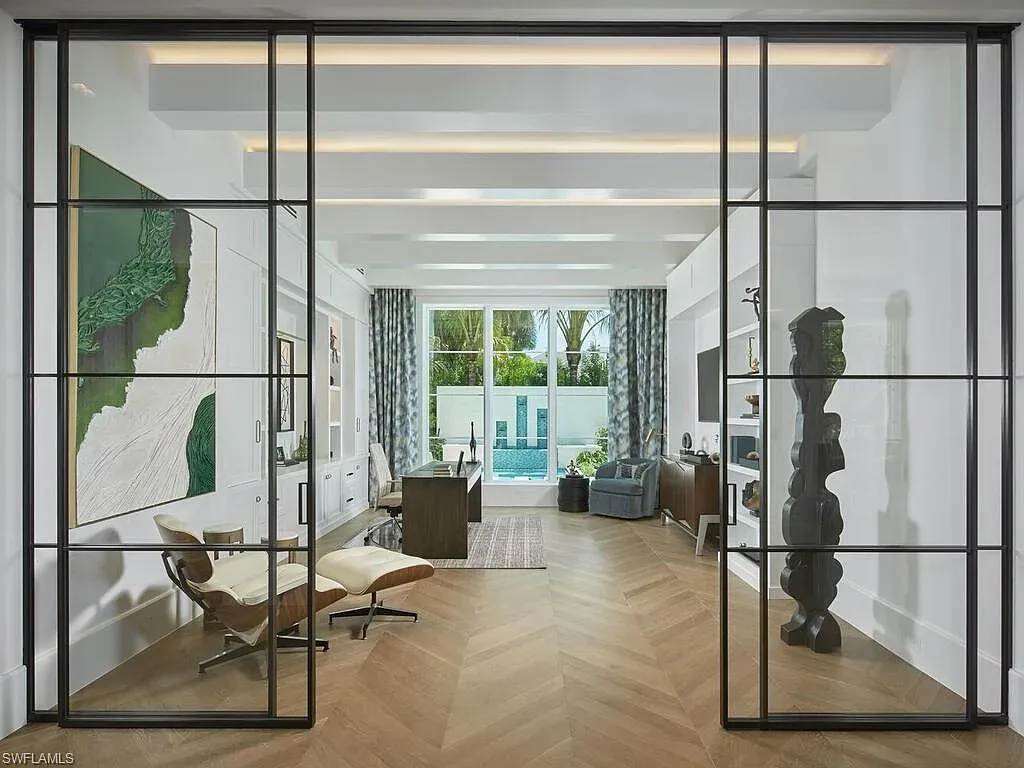 A $19.9 Million Stunning Tropical Contemporary Estate Steps From the Beach in Prestigious Naples 13 Tropical contemporary exterior of 2075 Gordon Dr E in Naples FL featuring a metal roof, stone accents, and lush landscaping near the beach