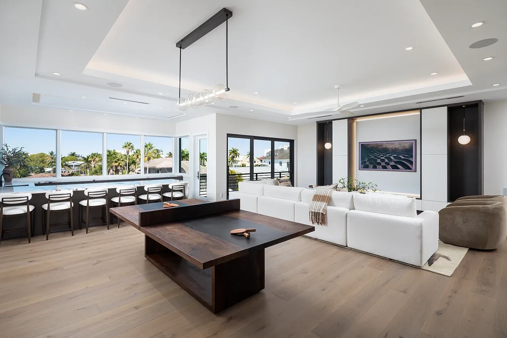 Interior and exterior views of 223 Bayview Avenue Naples FL showing 6-bedroom waterfront estate with modern coastal design, infinity pool, elevated terrace, and private dock.