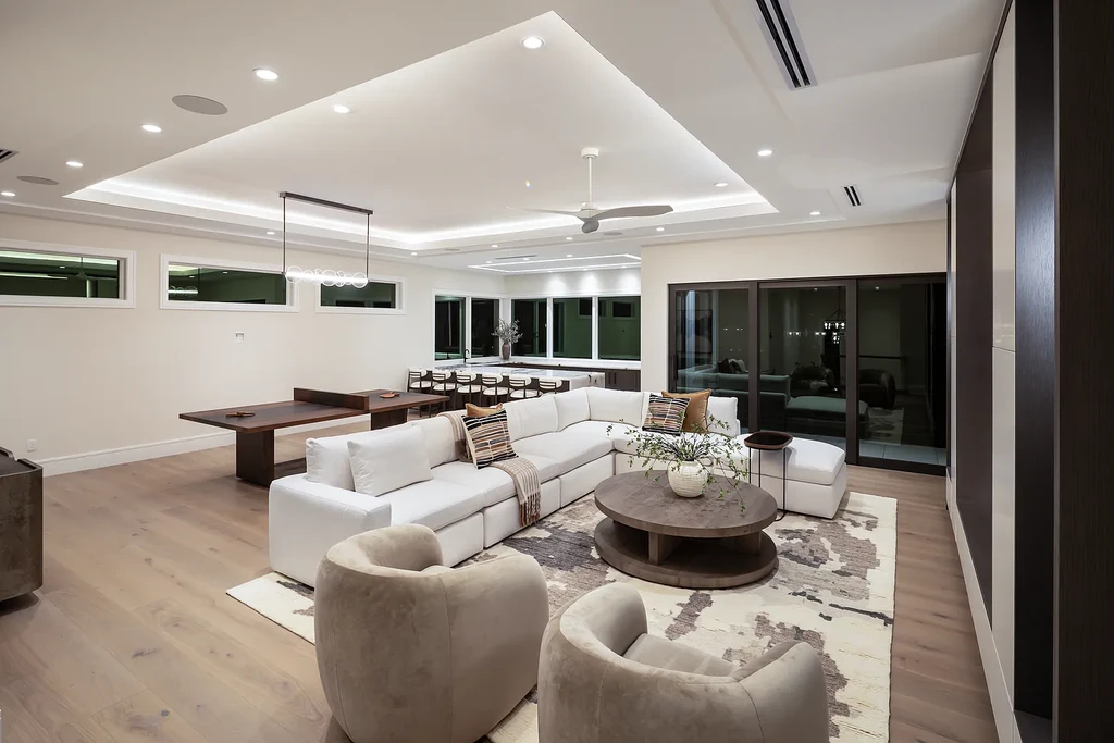 Interior and exterior views of 223 Bayview Avenue Naples FL showing 6-bedroom waterfront estate with modern coastal design, infinity pool, elevated terrace, and private dock.