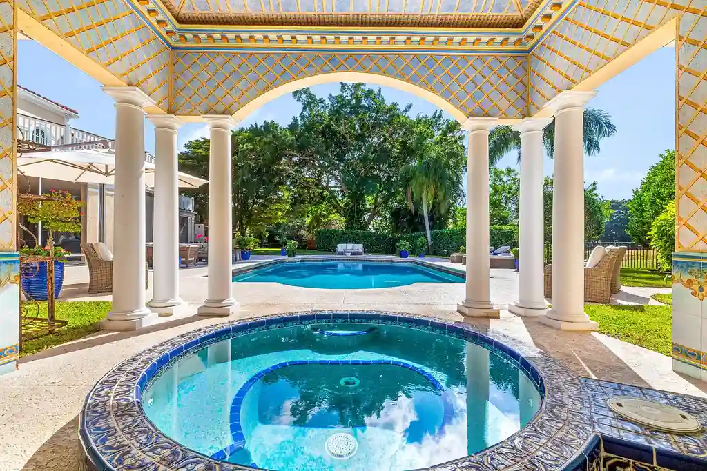 $13.5 Million Luxury Wellington Estate Featuring Private Tennis Court, Pool, and Equestrian Amenities 6 Outdoor pool and cabana at 2359 Muir Circle, Wellington, surrounded by manicured gardens and private tennis court