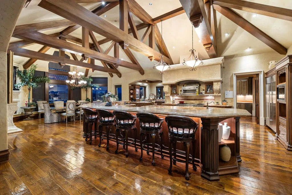 The Pennington Mansion at 2490 Manzanita Ln Hits the Market for $13,950,000, Introducing One of Reno’s Most Spectacular Trophy Estates 9 Chef’s kitchen at the Pennington Mansion featuring exposed truss ceilings a large central island bar seating custom cabinetry and luxury appliances.