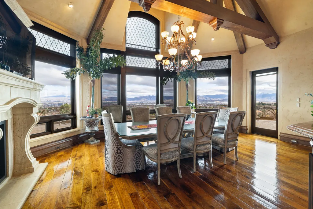 The Pennington Mansion at 2490 Manzanita Ln Hits the Market for $13,950,000, Introducing One of Reno’s Most Spectacular Trophy Estates 10 Dining room at the Pennington Mansion featuring large arched windows expansive mountain and city views exposed beams and an elegant chandelier over a long table.