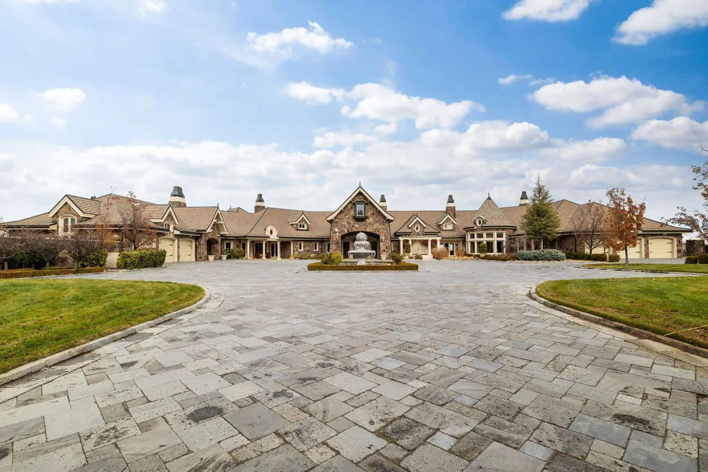 The Pennington Mansion at 2490 Manzanita Ln Hits the Market for $13,950,000, Introducing One of Reno’s Most Spectacular Trophy Estates 13 Front motor court of the Pennington Mansion featuring an expansive stone driveway symmetrical architecture and a central fountain.