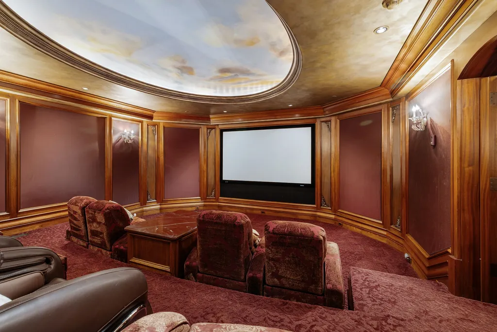The Pennington Mansion at 2490 Manzanita Ln Hits the Market for $13,950,000, Introducing One of Reno’s Most Spectacular Trophy Estates 11 Home theater at the Pennington Mansion featuring plush tiered seating rich wood paneling and a large projection screen beneath an artistic domed ceiling.