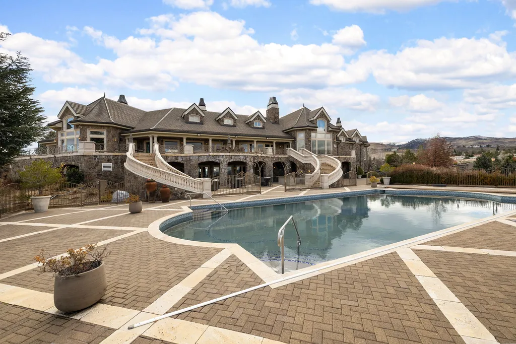 The Pennington Mansion at 2490 Manzanita Ln Hits the Market for $13,950,000, Introducing One of Reno’s Most Spectacular Trophy Estates 15 Pool terrace at the Pennington Mansion featuring a large curved swimming pool expansive stone patio and grand dual staircases leading to the upper level.