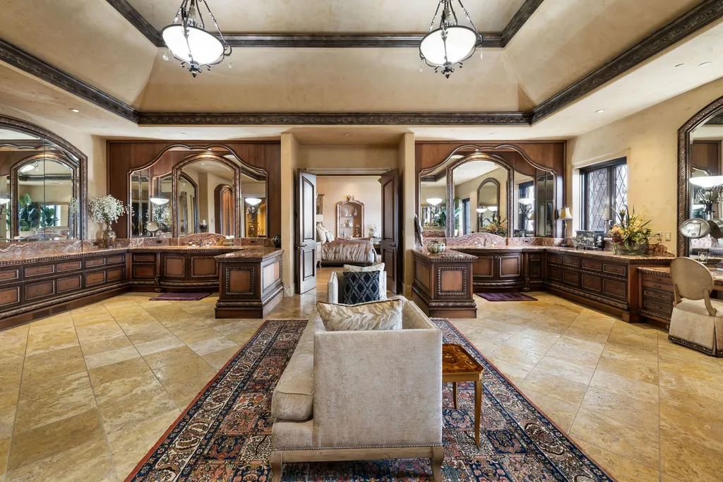 The Pennington Mansion at 2490 Manzanita Ln Hits the Market for $13,950,000, Introducing One of Reno’s Most Spectacular Trophy Estates 6 Lavish primary bath suite at the Pennington Mansion featuring dual vanity wings ornate wood cabinetry marble counters and vaulted ceilings with elegant lighting.