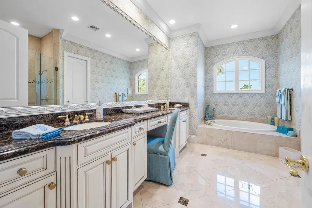 $12.5 Million Boca Raton Waterfront Estate Featuring Resort-Style Pool, and Private Dock 13 Resort-style backyard of Boca Raton estate featuring heated swimming pool, spa, outdoor lounge, and panoramic canal views