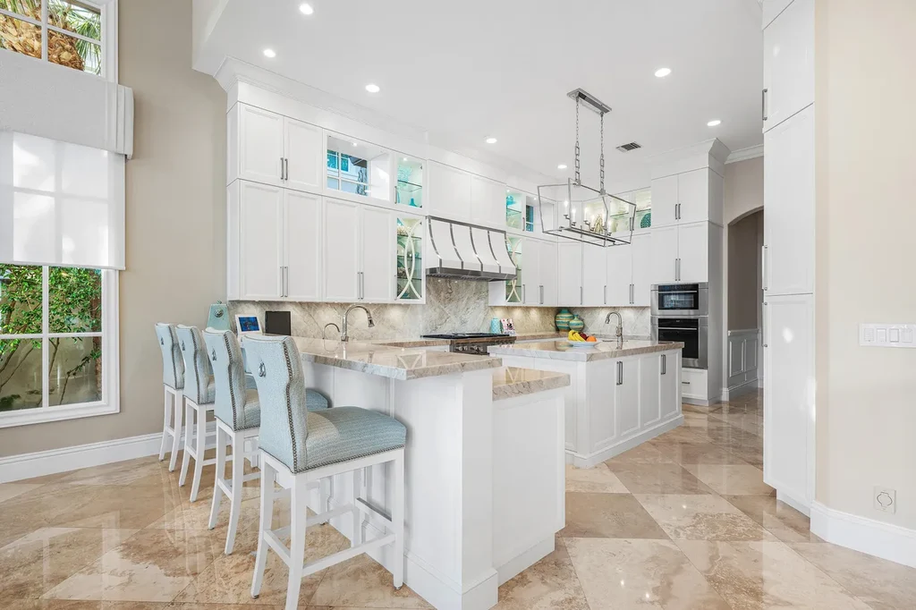 $12.5 Million Boca Raton Waterfront Estate Featuring Resort-Style Pool, and Private Dock 9 Resort-style backyard of Boca Raton estate featuring heated swimming pool, spa, outdoor lounge, and panoramic canal views