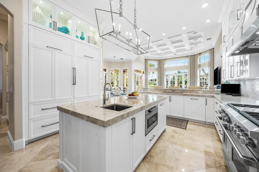 $12.5 Million Boca Raton Waterfront Estate Featuring Resort-Style Pool, and Private Dock 10 Resort-style backyard of Boca Raton estate featuring heated swimming pool, spa, outdoor lounge, and panoramic canal views