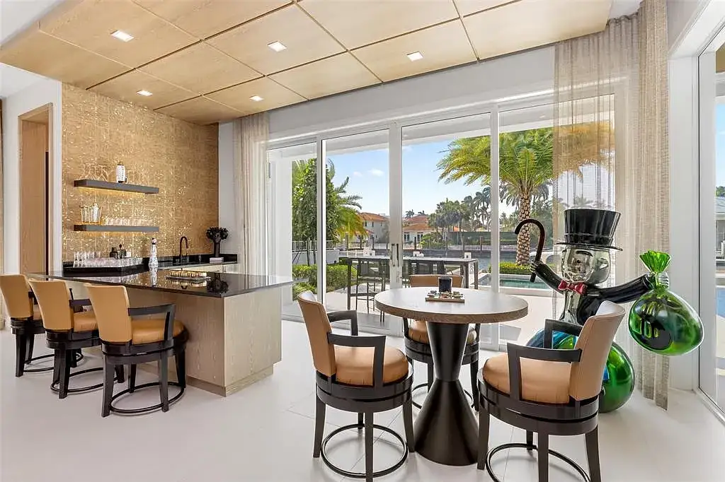 Ultra Luxury $28.4 Million Waterfront Estate Offering Exceptional Coastal Living in Fort Lauderdale 11 Luxurious waterfront exterior view of the modern estate at 2520 Del Lago Dr in Fort Lauderdale, showcasing the canal frontage, heated pool, and contemporary architectural design.