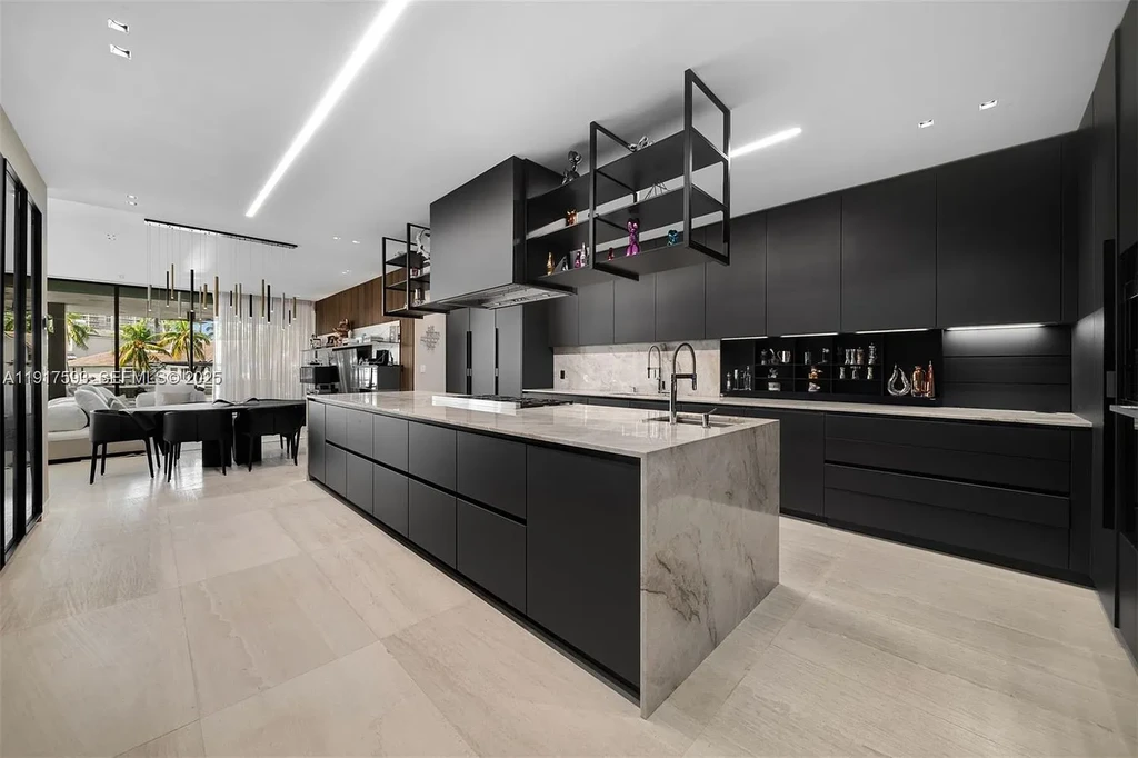 Exquisite $16.9 Million Modern Waterfront Estate in North Miami Beach Offers Unmatched Luxury and Elegance 12 Interior view of 342 S Pkwy showcasing open-plan living area, Mia Cucina kitchen, and luxury limestone flooring