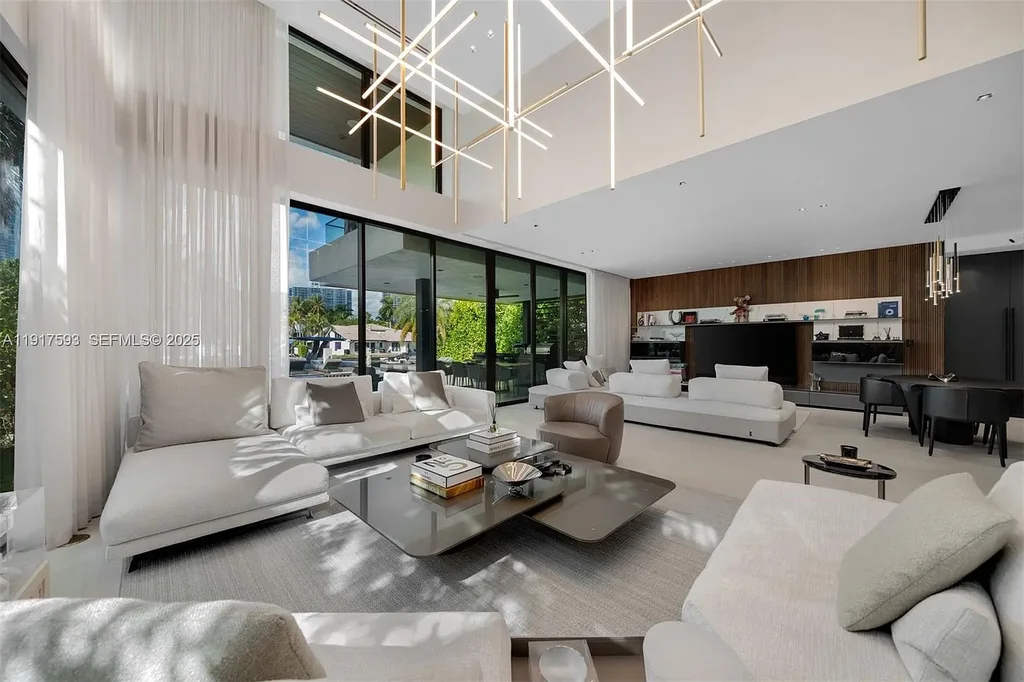 Exquisite $16.9 Million Modern Waterfront Estate in North Miami Beach Offers Unmatched Luxury and Elegance 8 Interior view of 342 S Pkwy showcasing open-plan living area, Mia Cucina kitchen, and luxury limestone flooring