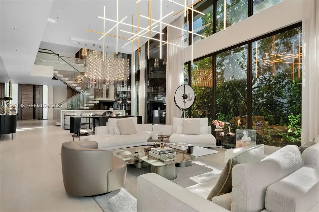 Exquisite $16.9 Million Modern Waterfront Estate in North Miami Beach Offers Unmatched Luxury and Elegance 9 Interior view of 342 S Pkwy showcasing open-plan living area, Mia Cucina kitchen, and luxury limestone flooring