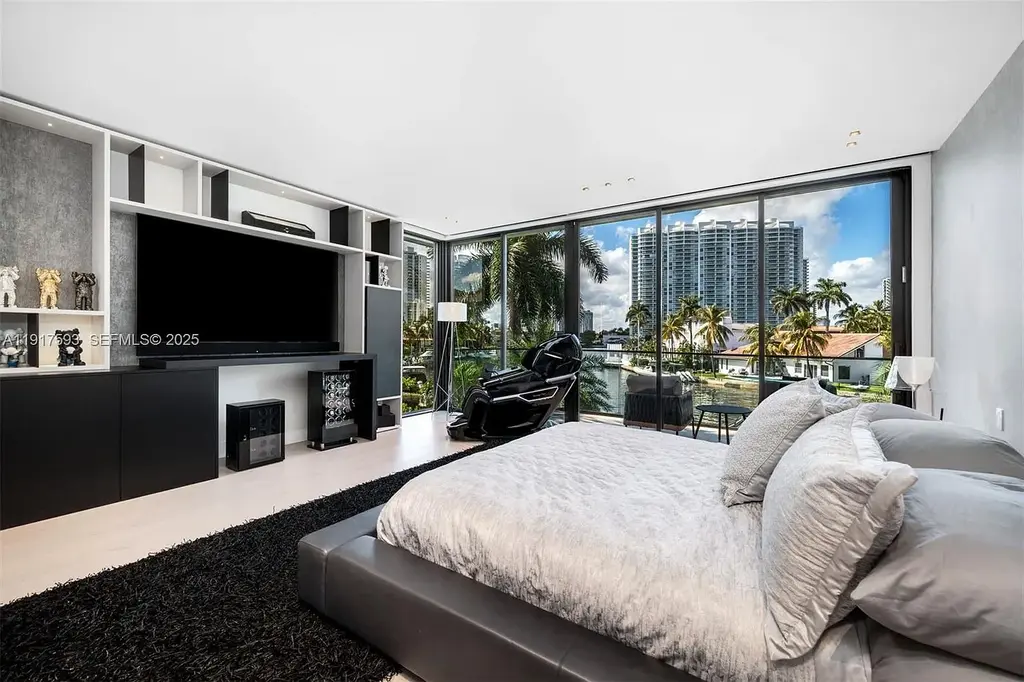Exquisite $16.9 Million Modern Waterfront Estate in North Miami Beach Offers Unmatched Luxury and Elegance 13 Interior view of 342 S Pkwy showcasing open-plan living area, Mia Cucina kitchen, and luxury limestone flooring