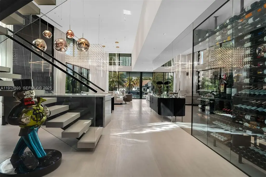 Exquisite $16.9 Million Modern Waterfront Estate in North Miami Beach Offers Unmatched Luxury and Elegance 6 Interior view of 342 S Pkwy showcasing open-plan living area, Mia Cucina kitchen, and luxury limestone flooring