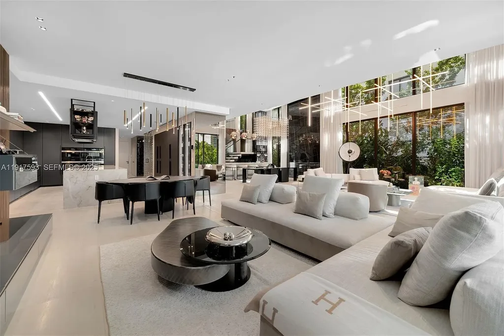 Exquisite $16.9 Million Modern Waterfront Estate in North Miami Beach Offers Unmatched Luxury and Elegance 7 Interior view of 342 S Pkwy showcasing open-plan living area, Mia Cucina kitchen, and luxury limestone flooring