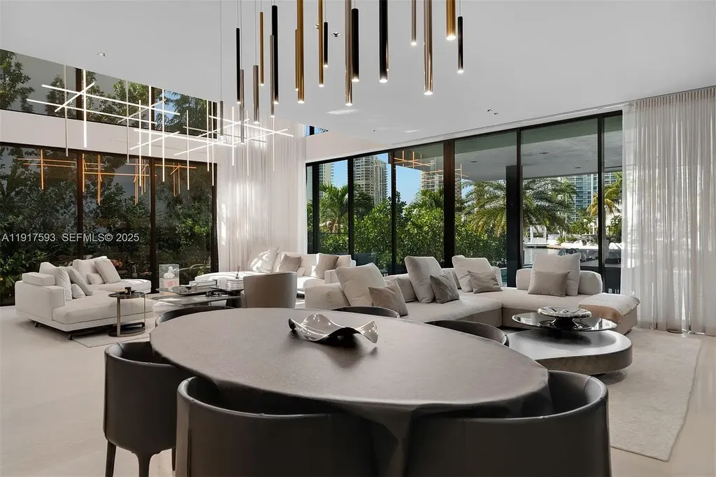 Exquisite $16.9 Million Modern Waterfront Estate in North Miami Beach Offers Unmatched Luxury and Elegance 11 Interior view of 342 S Pkwy showcasing open-plan living area, Mia Cucina kitchen, and luxury limestone flooring