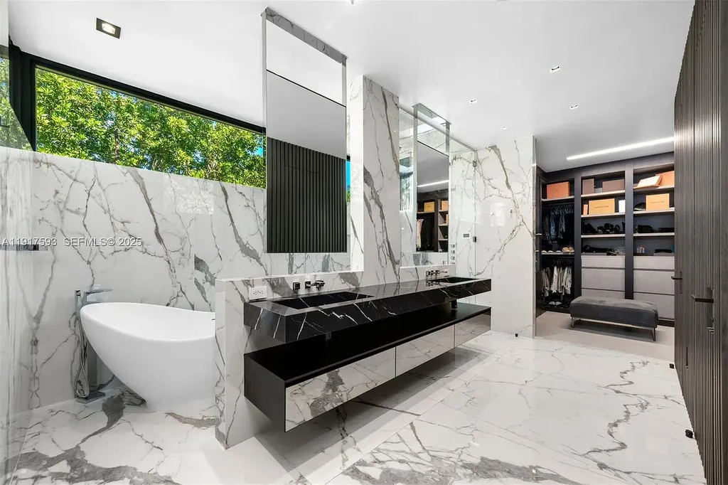 Exquisite $16.9 Million Modern Waterfront Estate in North Miami Beach Offers Unmatched Luxury and Elegance 14 Interior view of 342 S Pkwy showcasing open-plan living area, Mia Cucina kitchen, and luxury limestone flooring