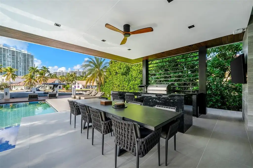 Exquisite $16.9 Million Modern Waterfront Estate in North Miami Beach Offers Unmatched Luxury and Elegance 16 Interior view of 342 S Pkwy showcasing open-plan living area, Mia Cucina kitchen, and luxury limestone flooring