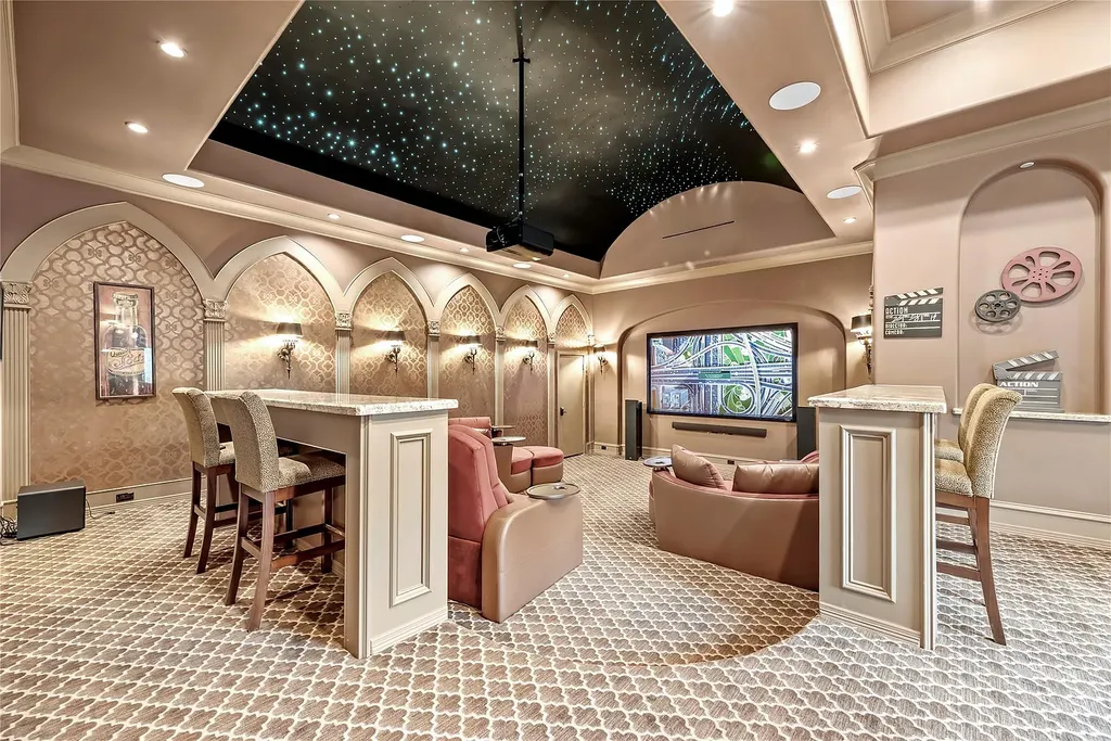 A Mediterranean Masterpiece Rising Above the Woodlands of Magnolia, Texas Seeks for $11,500,000 12 Luxury home theater at 38262 Windy Ridge Trail in Magnolia, Texas, featuring star-lit fiber-optic ceiling, tiered seating, arched wall detailing, plush carpeting, and a large projection screen.