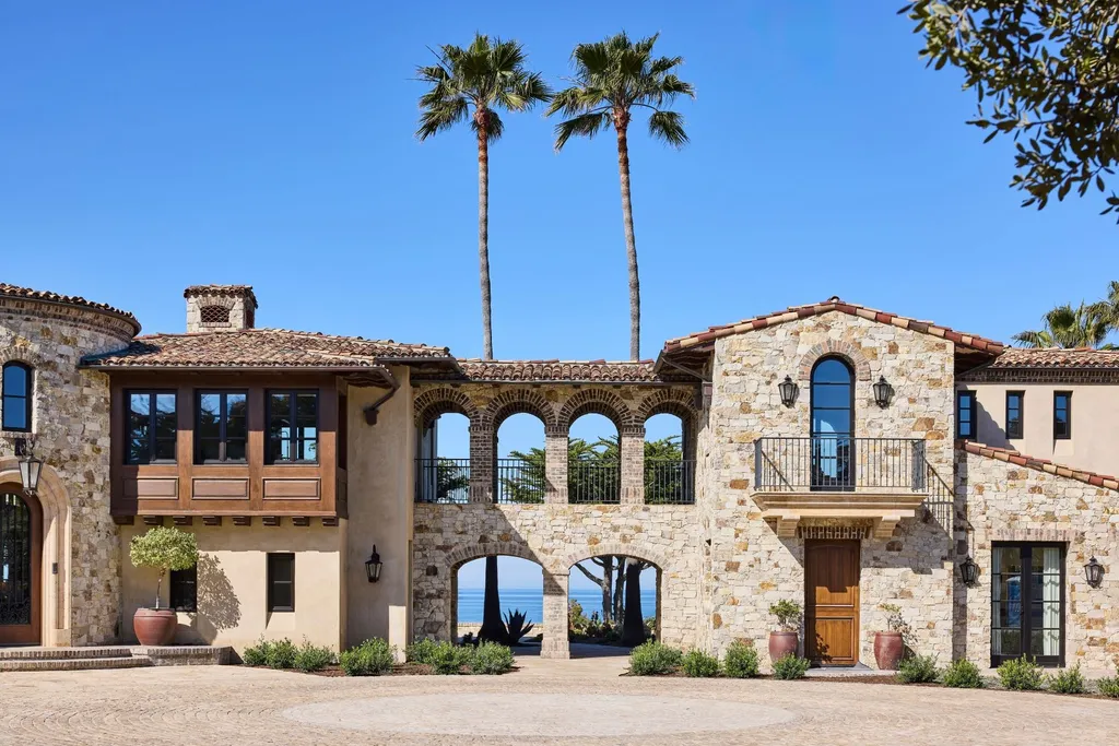 Oceanfront Masterwork Listed at 43 Million Presents One of Southern California’s Most Extraordinary Blufftop Estates 11 Stone facade of 4130 Calle Isabella in San Clemente showcasing arched breezeways, balcony, and Mediterranean architectural details.