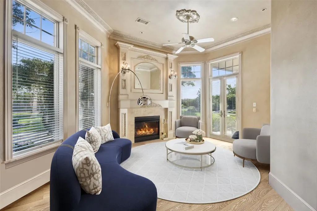 A $6.975 Million Steel Framed Estate Anchors Tour 18’s Most Enduring Address 7 Sitting area with fireplace inside the primary suite at 5700 Masters Ct in Flower Mound, Texas