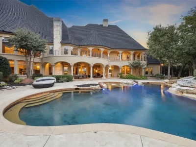 A $6.975 Million Steel Framed Estate Anchors Tour 18’s Most Enduring Address 3 Resort style swimming pool and rear facade of the steel framed estate at 5700 Masters Ct, Flower Mound, Texas