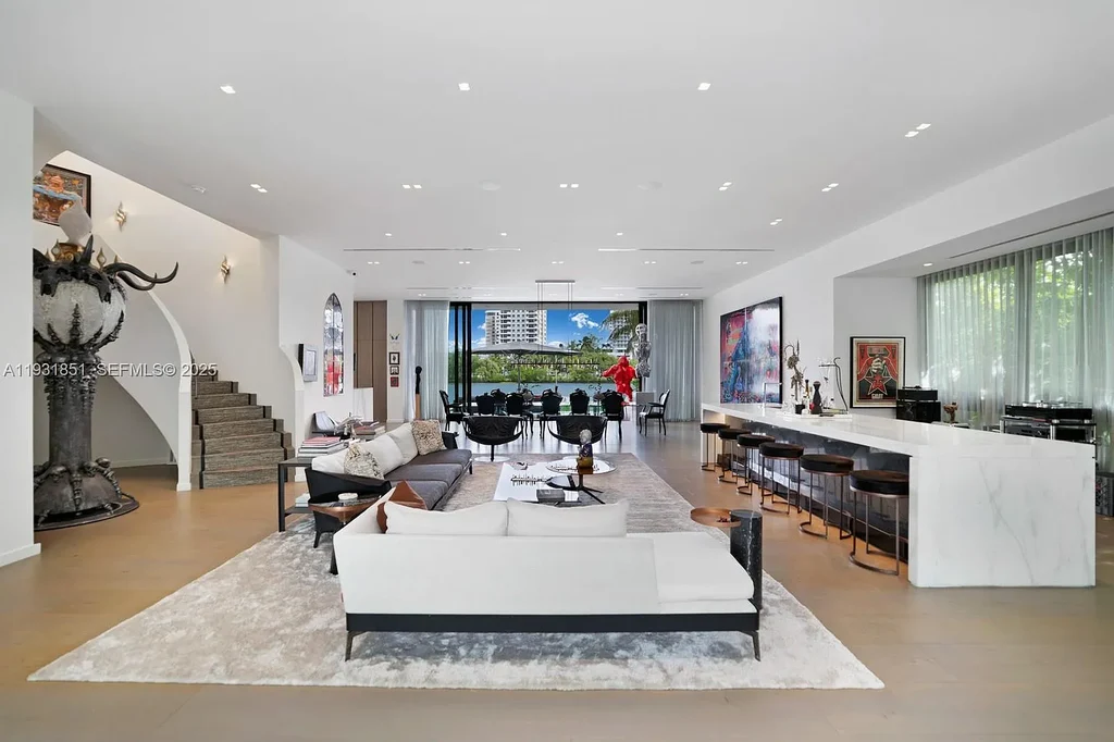 A $26 Million Tropical Modern Waterfront Estate Redefining Private Island Living in Miami Beach 7 Exterior of 6411 Allison Rd, a $26 million tropical modern home in Miami Beach with floor-to-ceiling glass