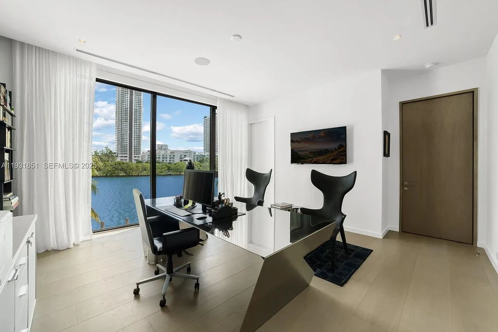 A $26 Million Tropical Modern Waterfront Estate Redefining Private Island Living in Miami Beach 15 Exterior of 6411 Allison Rd, a $26 million tropical modern home in Miami Beach with floor-to-ceiling glass