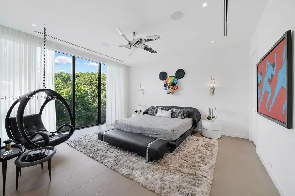 A $26 Million Tropical Modern Waterfront Estate Redefining Private Island Living in Miami Beach 10 Exterior of 6411 Allison Rd, a $26 million tropical modern home in Miami Beach with floor-to-ceiling glass